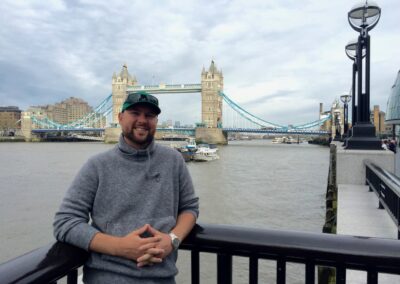 Picture of Danan Coleman with Tower Bridge in the background in London England - Photograph by Adventure With Danan