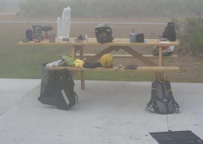 Motorcycle gear laid out on a picnic table in the fog