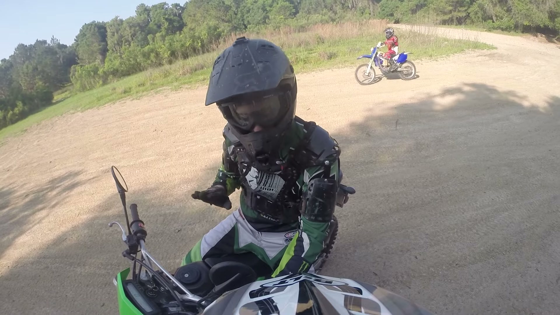 Dirt Biking the Croom Motorcycle Area 13 A rider in green gear taking a break in the open sand pit at Croom