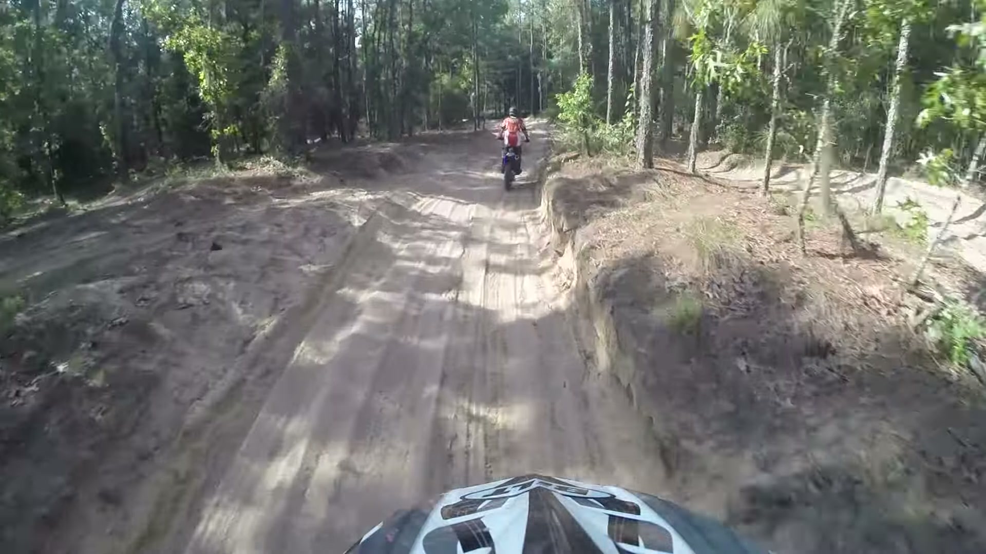 Dirt Biking the Croom Motorcycle Area 3 A rider ahead on a rutted sand whoops trail through the pine forest at Croom