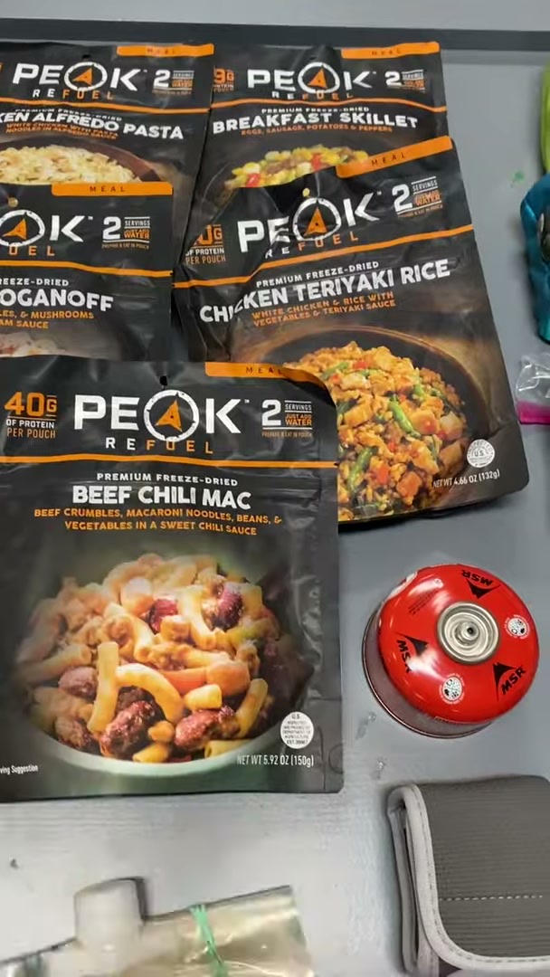 Packing a Motorcycle for a 30-Day Adventure Ride 5 Freeze-dried backpacking meals next to a camp stove fuel canister and cook kit