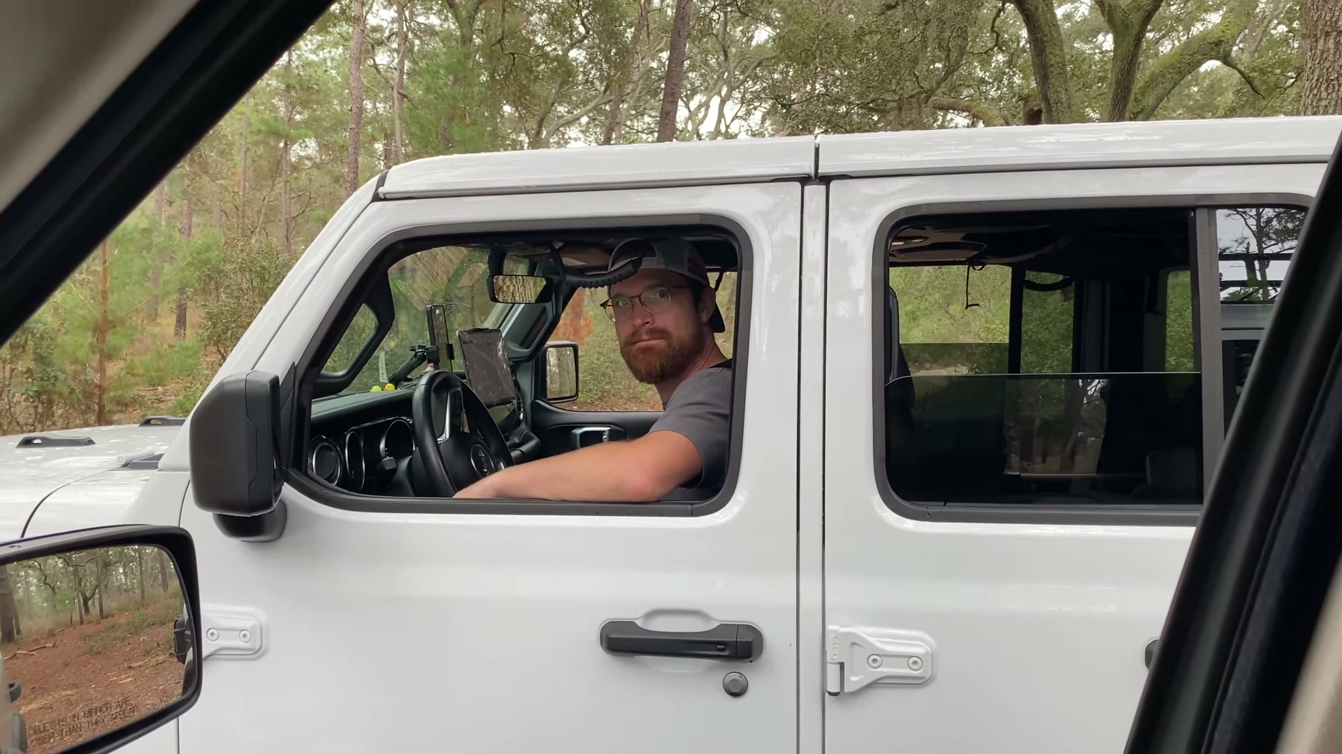 One Night in Ocala National Forest: Camp Cooking, Car Camping and Lake Dorr 7 Matt behind the wheel of his white Jeep Wrangler on the trail in Ocala National Forest