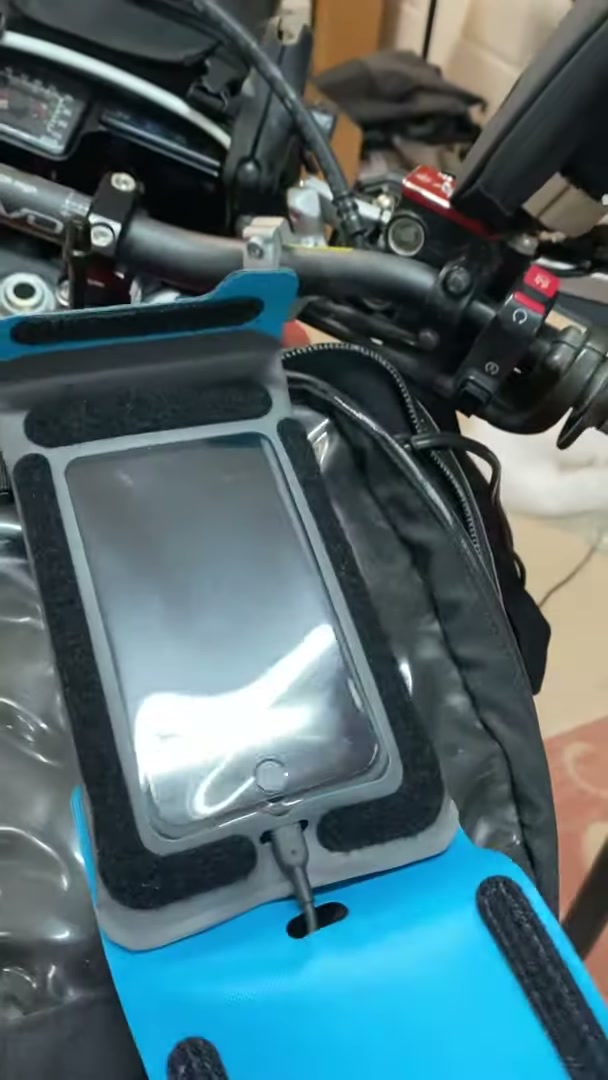 Packing a Motorcycle for a 30-Day Adventure Ride 10 A phone holder mounted on the handlebars of the XR650L