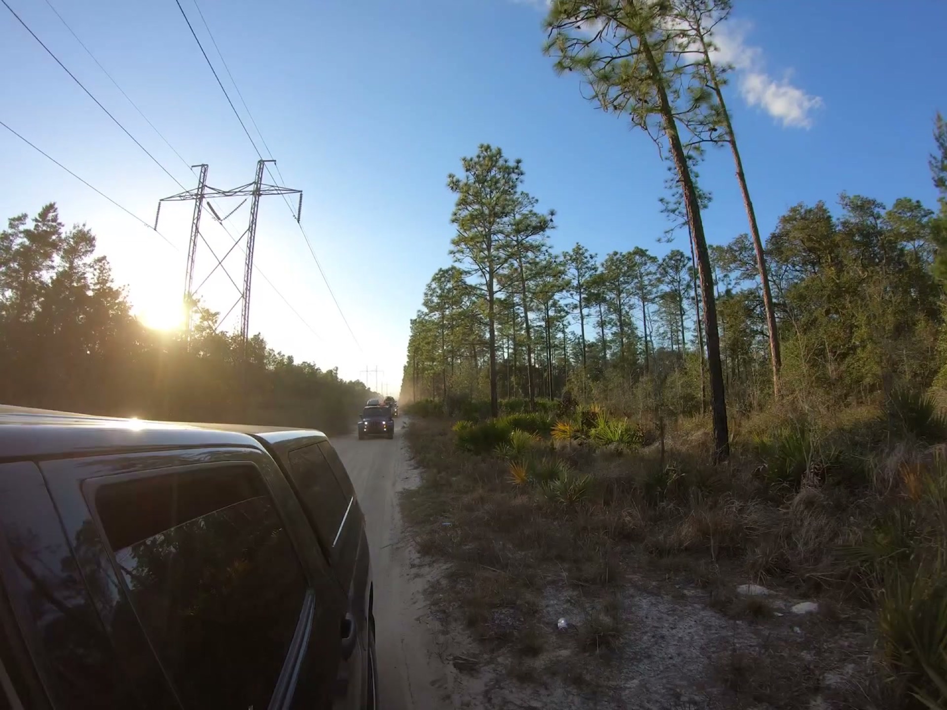 The Rally Point: Overlanding Hopkins Prairie in Ocala 17 Sunset behind the power lines as the convoy rolls on