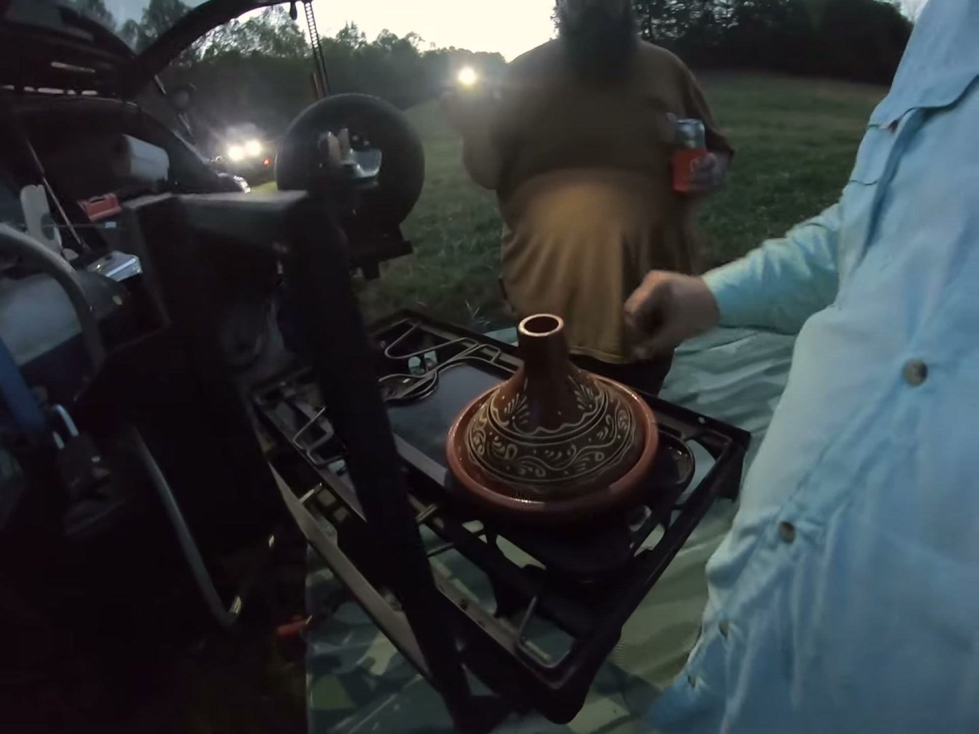 Campsite Cooking: Chicken Tagine with the Overland Crew 8 The tagine cooking on a camp stove at dusk while the crew waits
