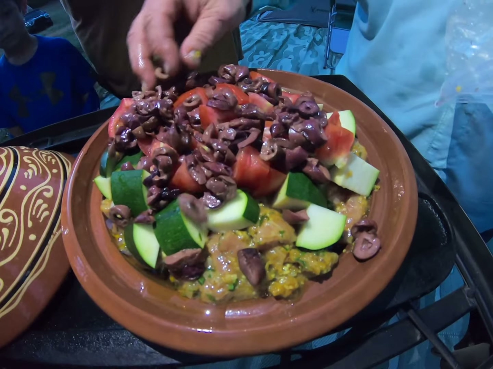 Campsite Cooking: Chicken Tagine with the Overland Crew 6 Tomatoes and olives layered into the tagine