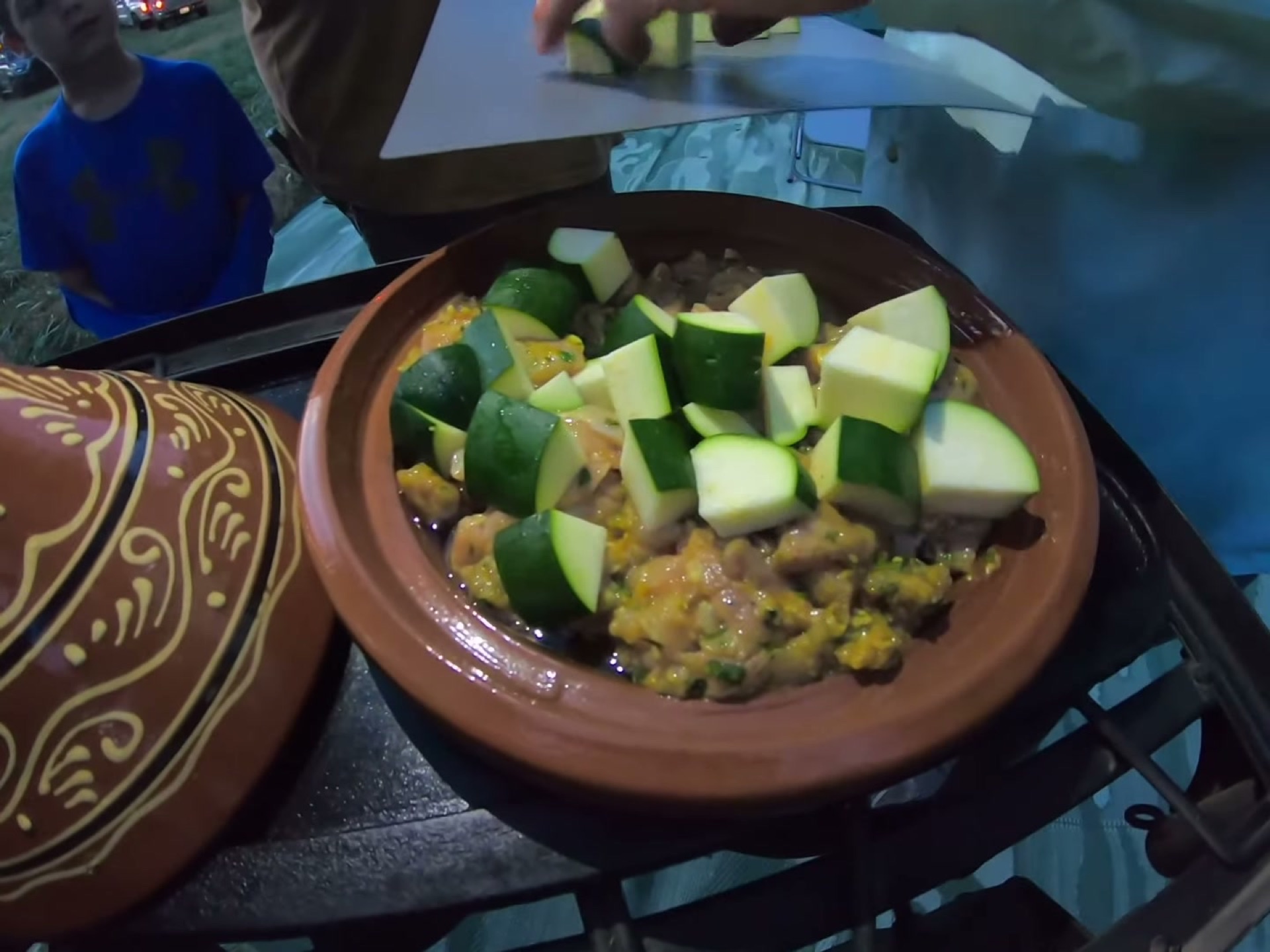 Campsite Cooking: Chicken Tagine with the Overland Crew 5 Zucchini chunks layered on top of the chicken in the tagine