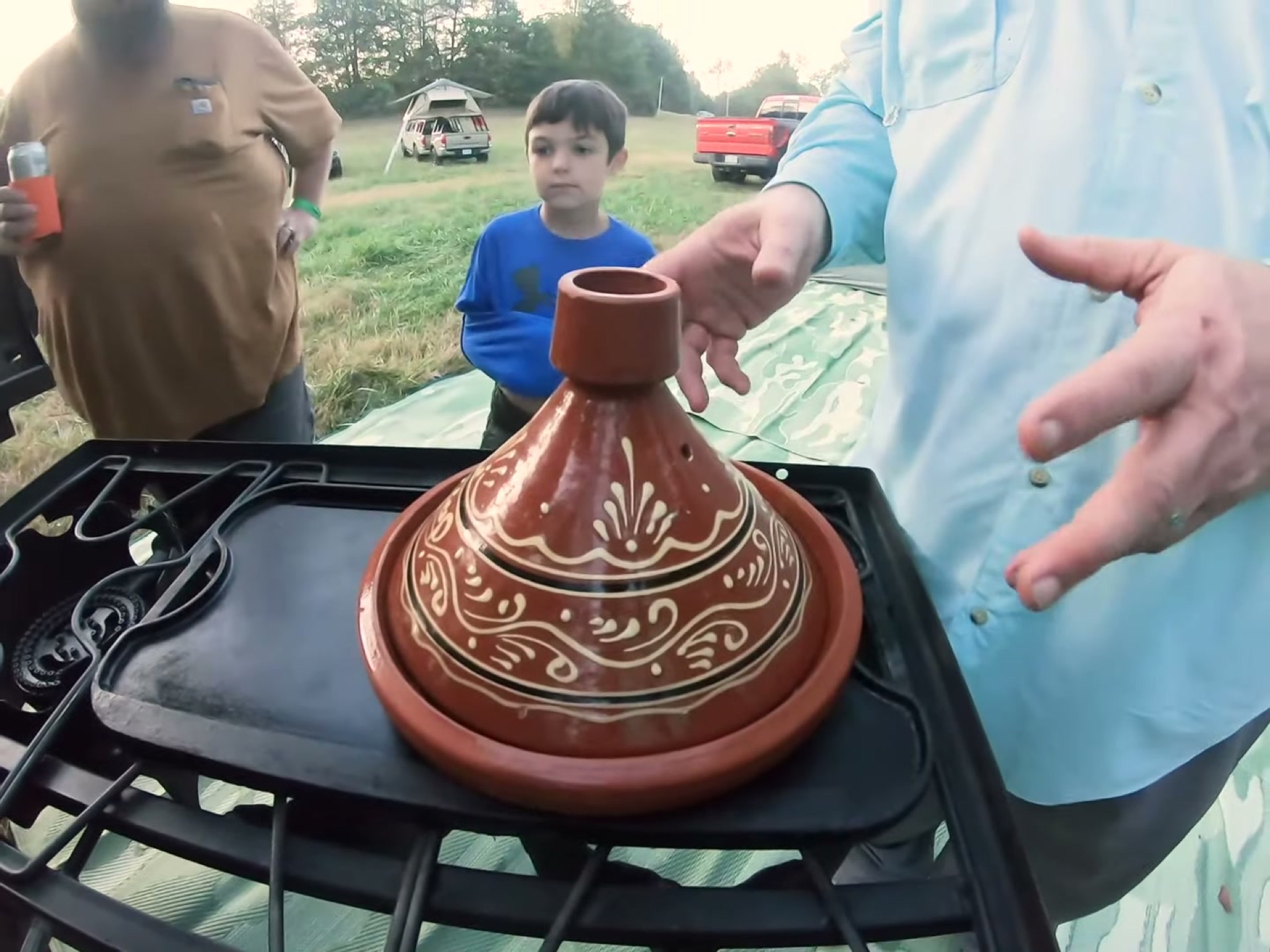 Campsite Cooking: Chicken Tagine with the Overland Crew 12 The tagine on the griddle with the crew looking on